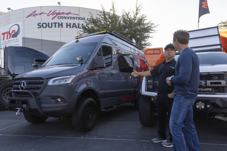 Jeremy talking to another man about his van outside the 2023 SEMA show