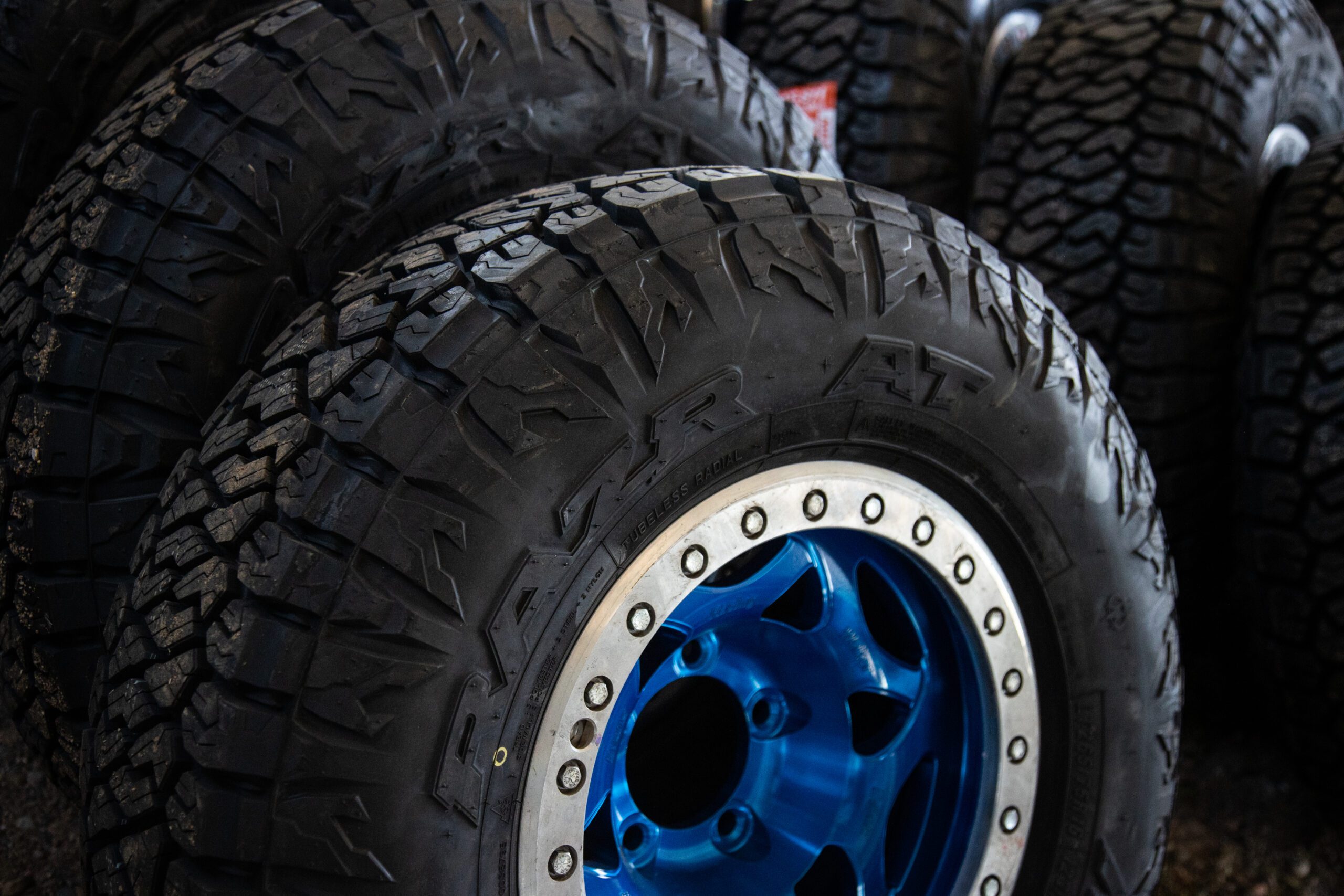 Two Razr AT Maxxis tires leaning against eachother waiting to be installed on a race truck.