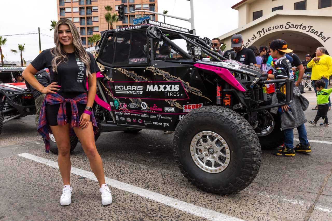 Sierra Romo smiling while standing in front of her pink and black SxS.