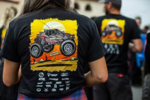 Image of a cartoon drawing of Sierra Romo's SxS on the back of a black T-Shirt