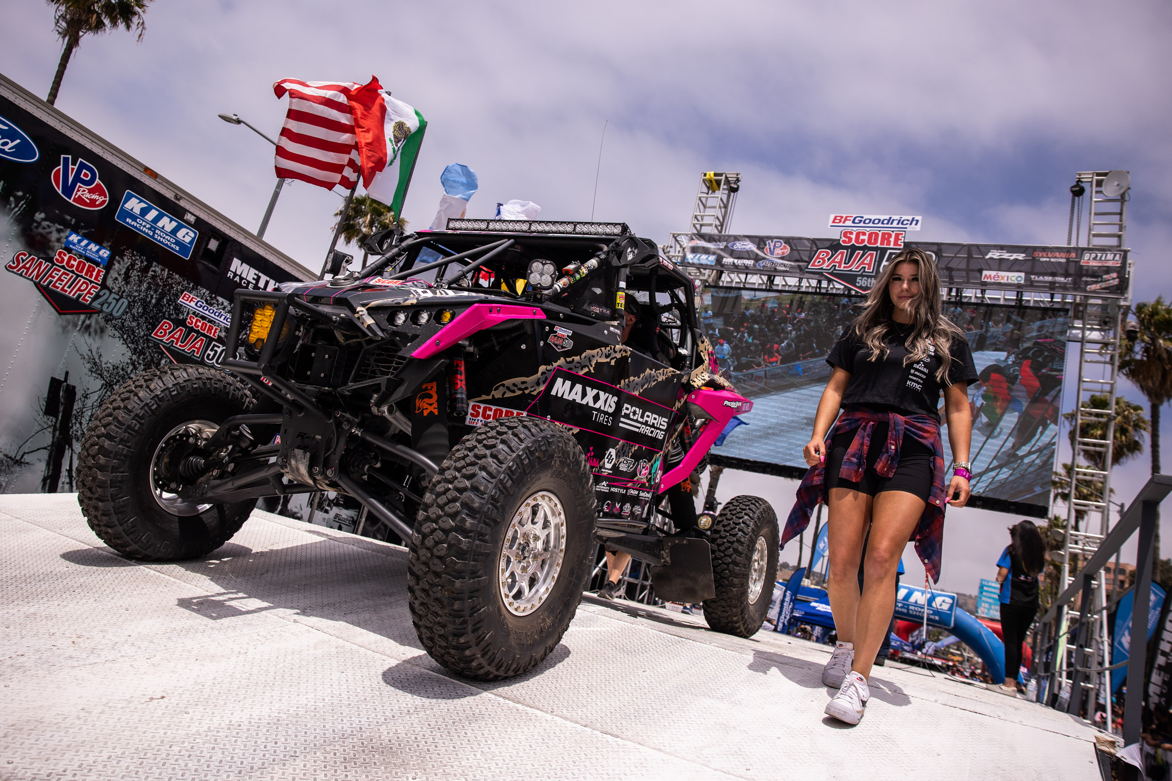 Sierra Romo walking down from the contingency stage next to her Pink and black SxS
