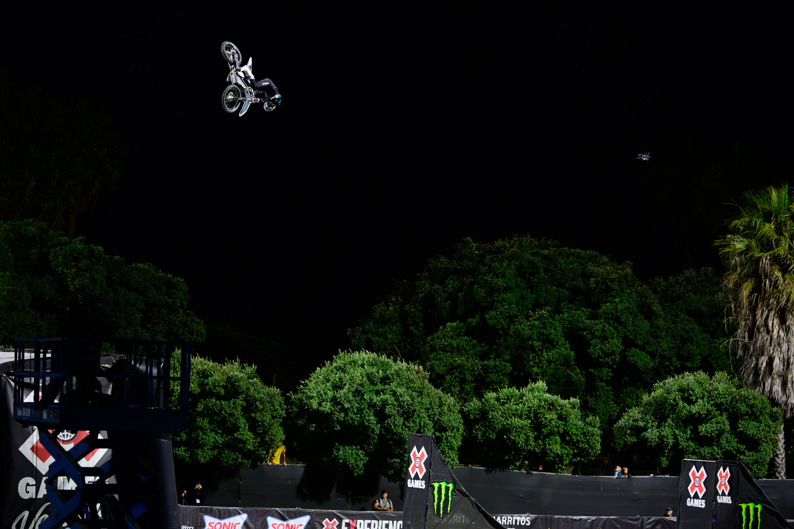 Wide shot of Patrick Evans in mid air over the 75 foot freestyle moto gap at X Games.