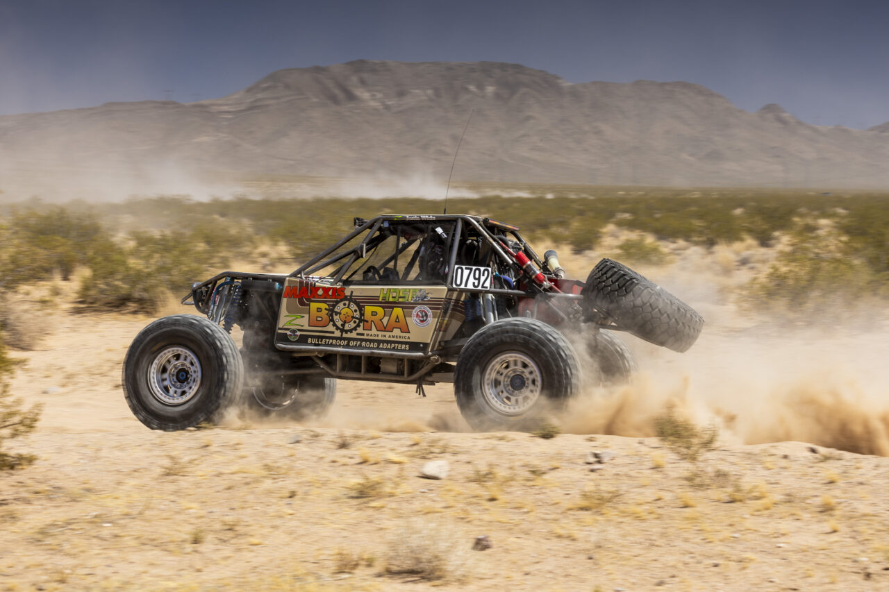 Maxxis sponsored 4400 truck flying through the desert.