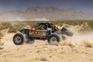 Maxxis sponsored 4400 truck flying through the desert.