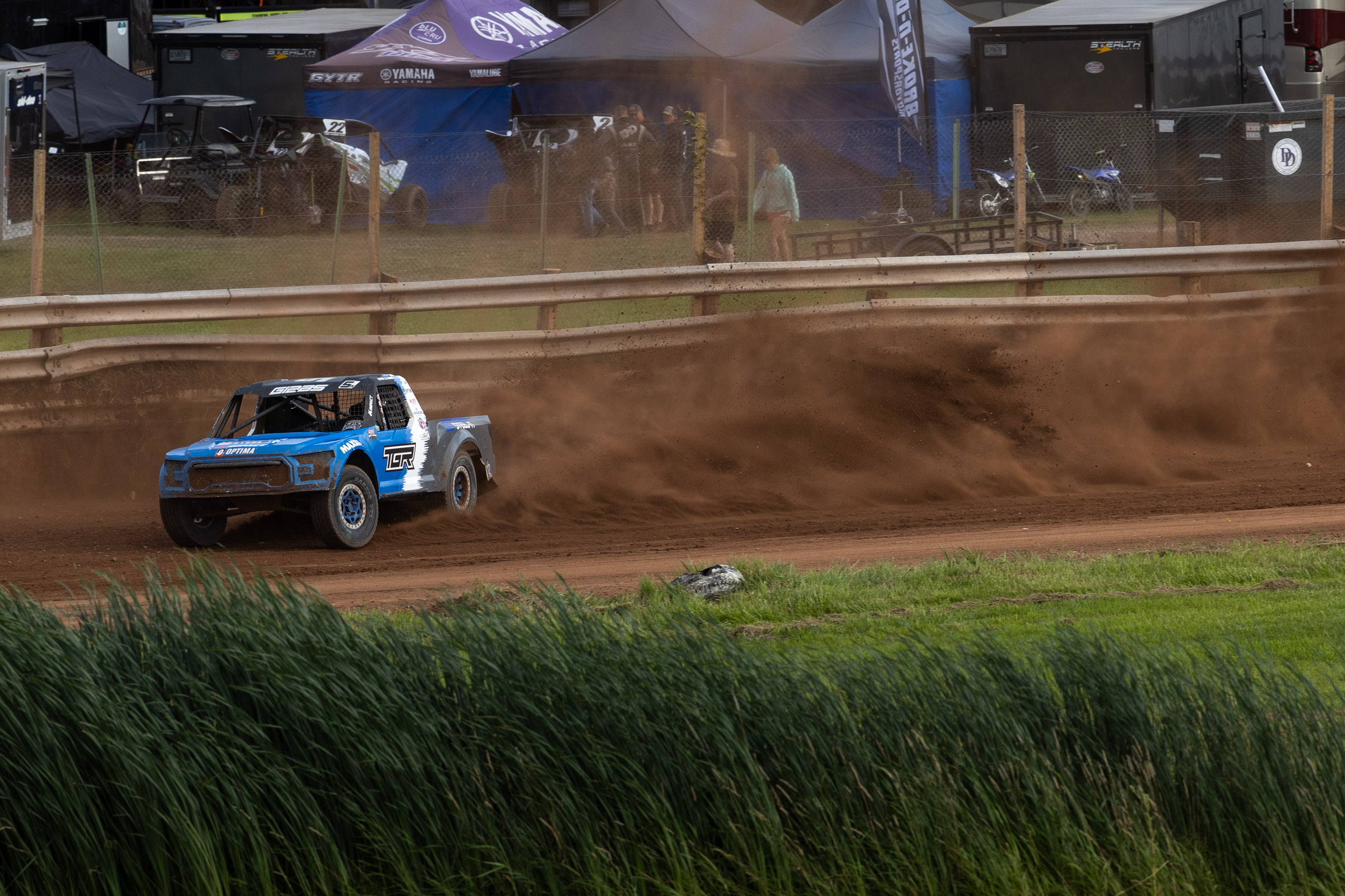 Maxxis sponsored truck throwing some dirt up on the race track