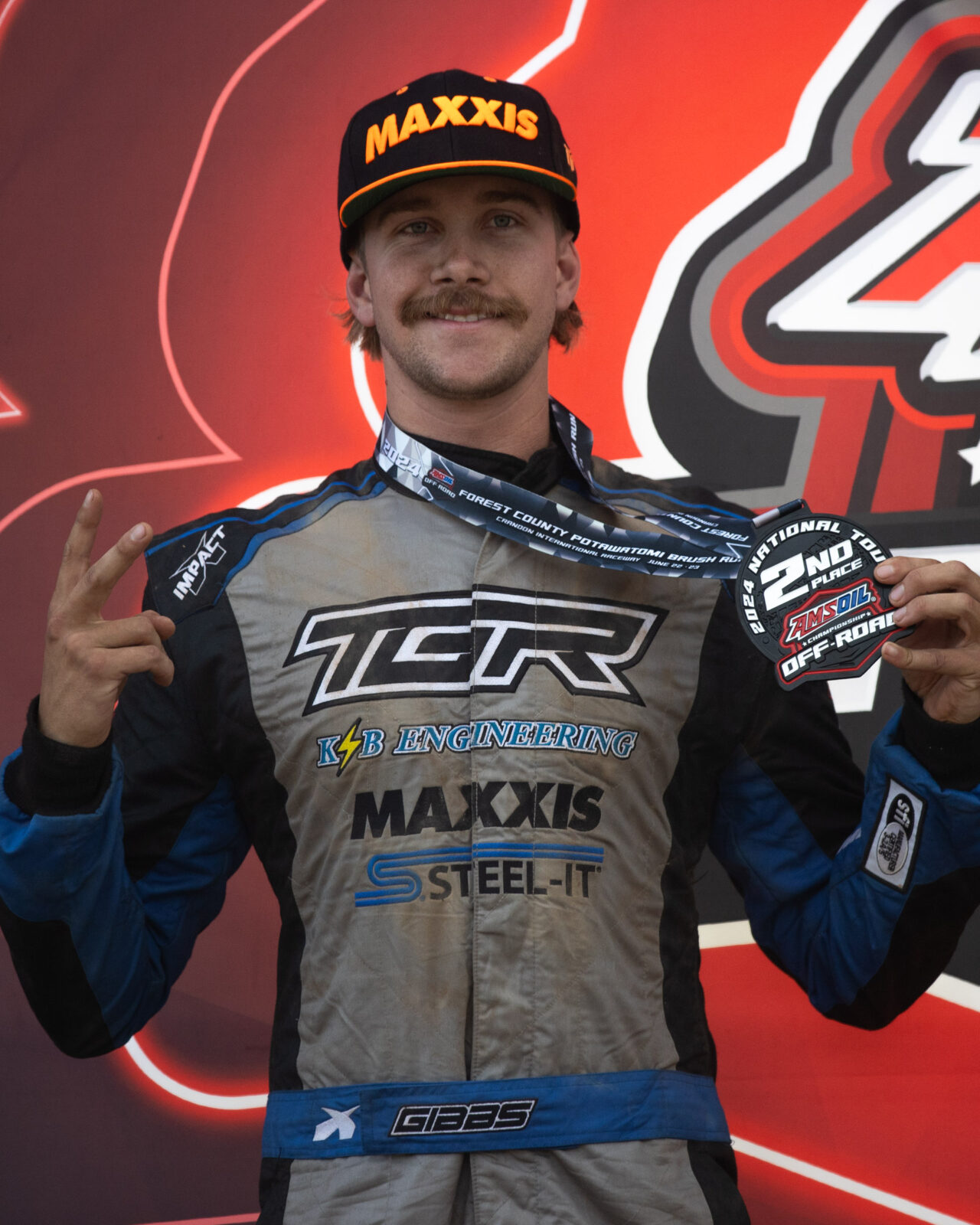 Maxxis athlete on the podium following a race.