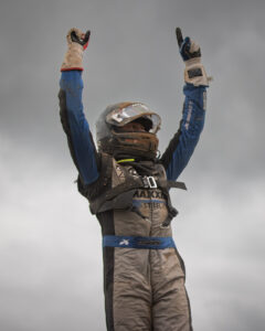 Maxxis athlete holding arms up in celebration.