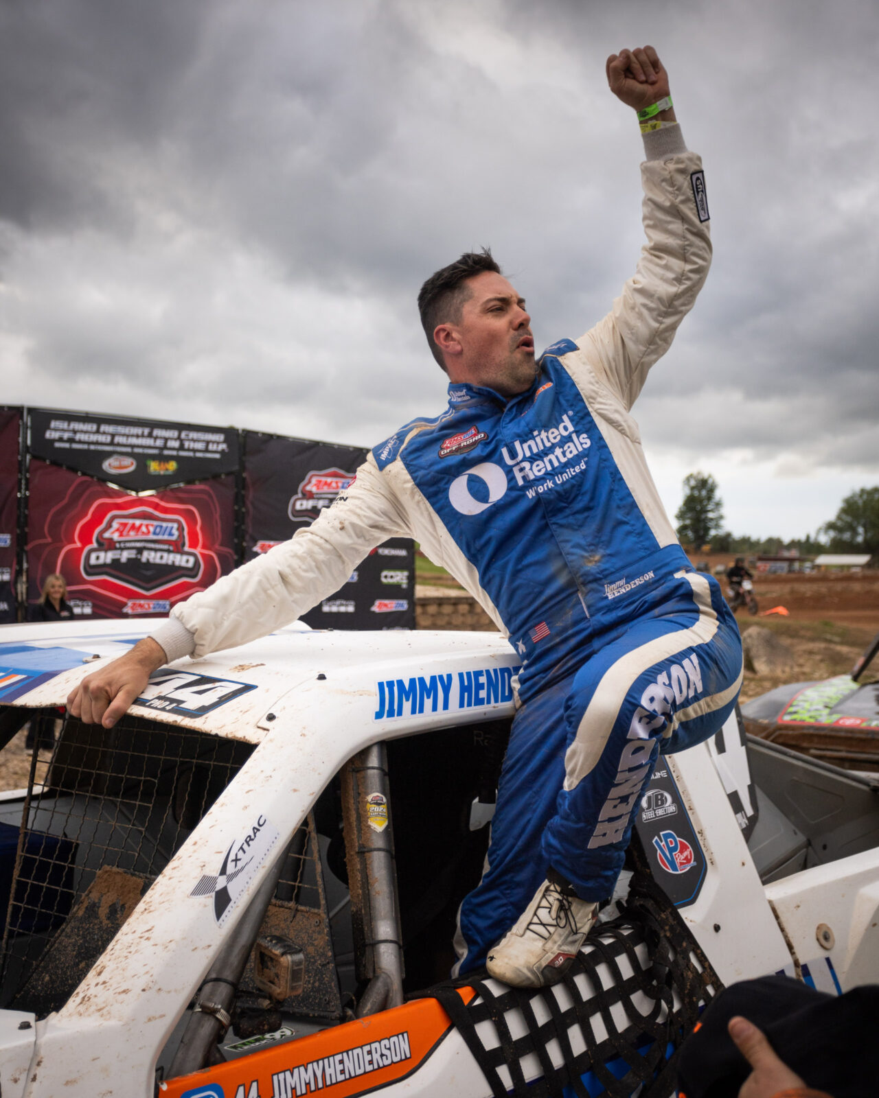 Maxxis athlete holding arm up in celebration.