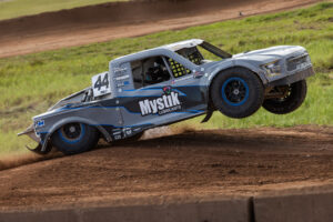 Maxxis sponsored truck launching off a jump.