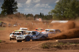Multiple trucks racing on the course.