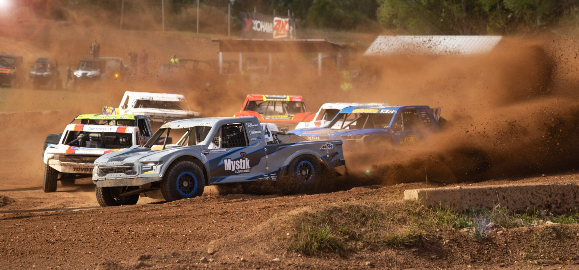 Multiple trucks racing on the track.