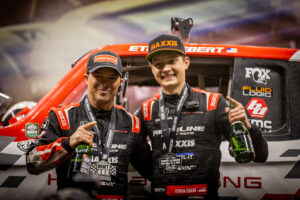 Ethan Ebert and his old Co Driver on the podium after a win in the Mint 400 in 2023.