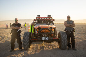 Maxxis athletes posted up next to their truck.
