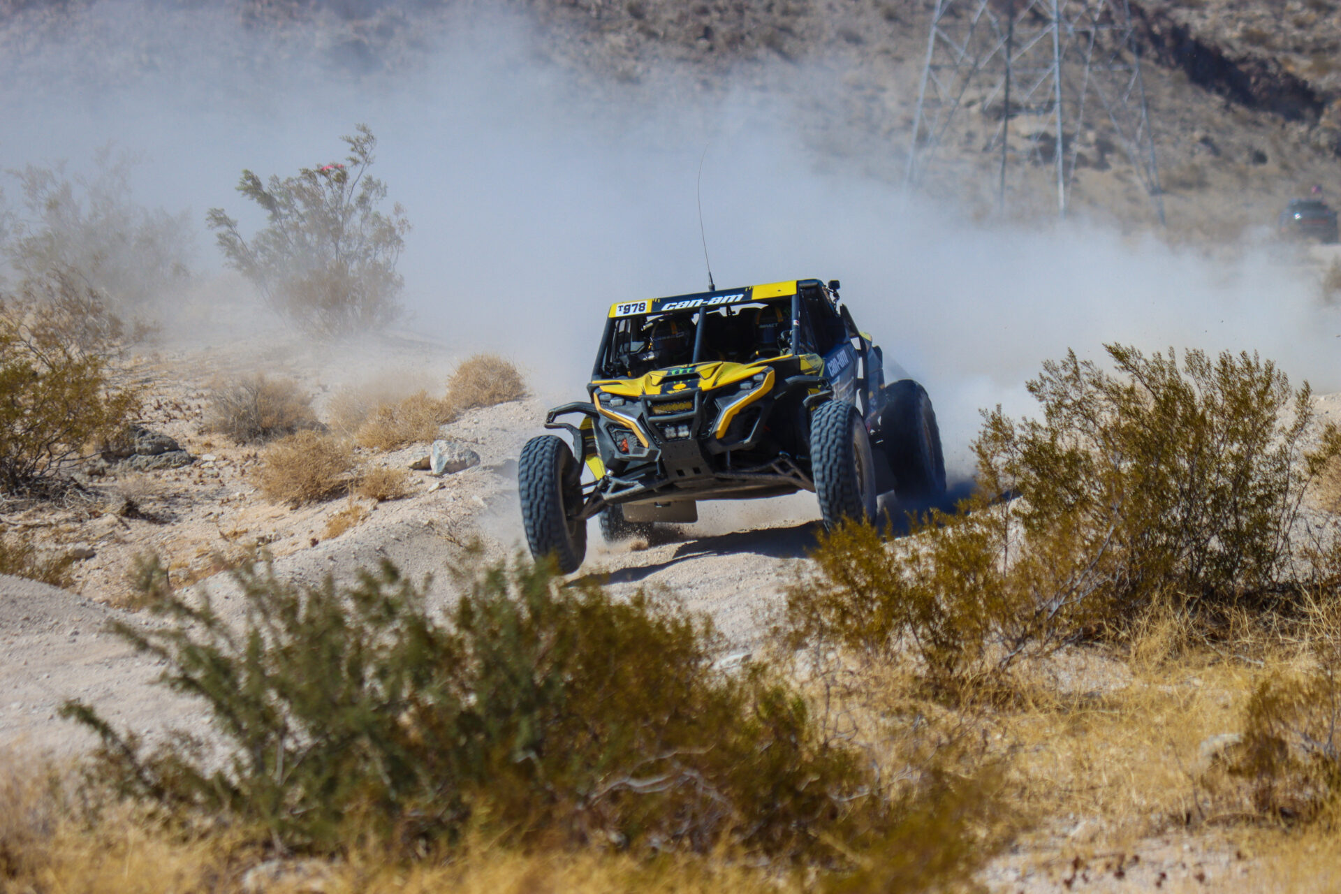 Dustin Jones racing through the Laughlin desert in his black and yellow Can Am on Maxxis Razr XTs