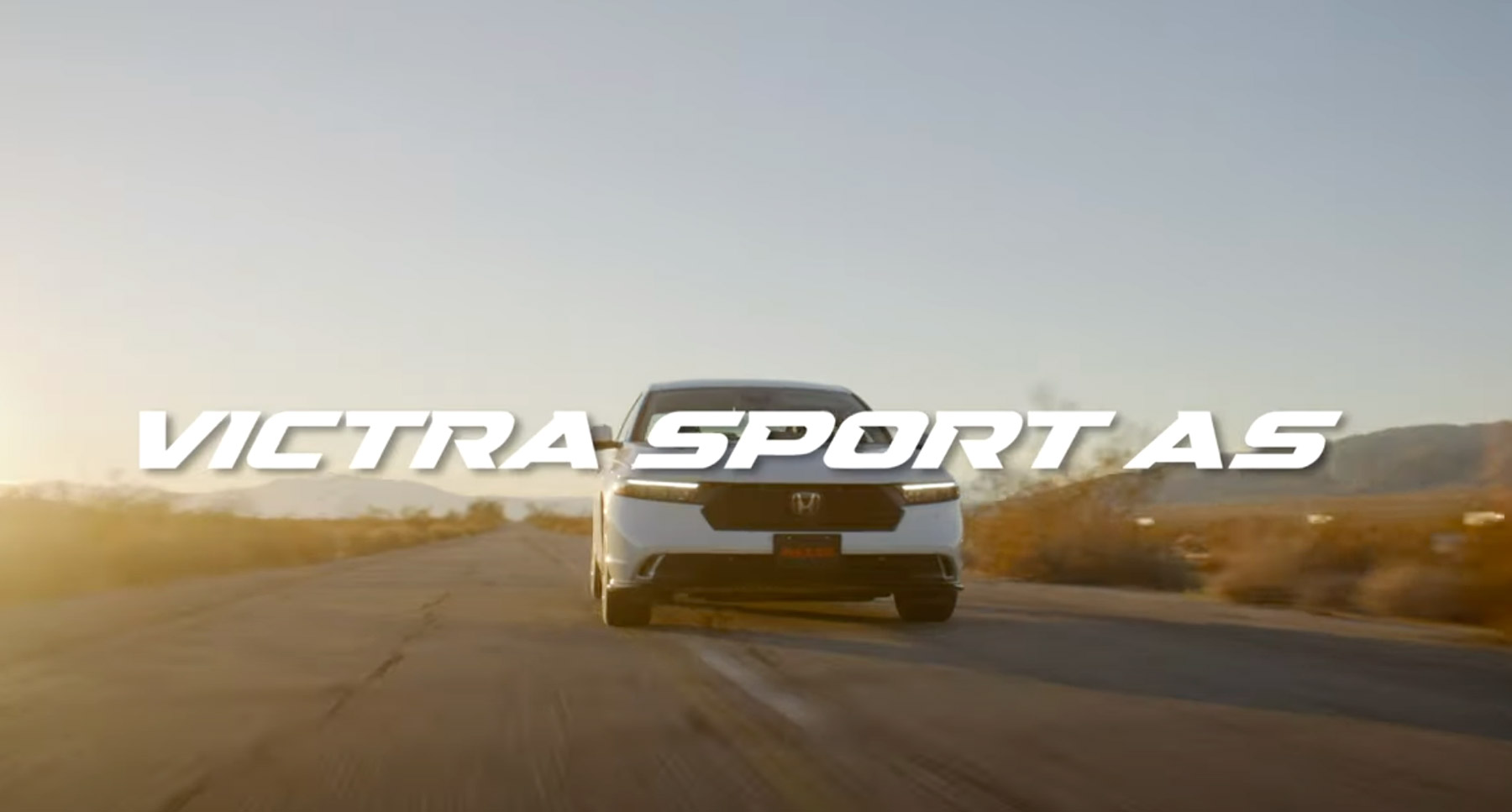 Car driving on a desert road with VICTRA SPORT AS text.