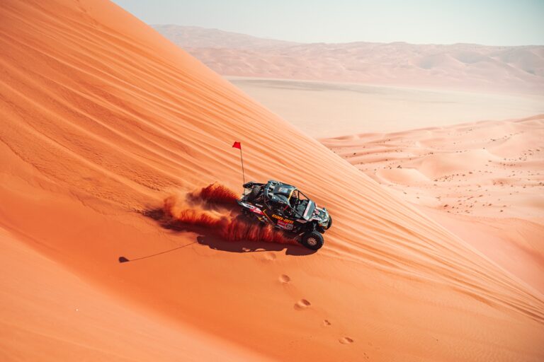 Hunter Miller Racing through the Saudi Arabian Desert in his yellow and black Factory Can-Am fitted with Maxxis Roxxzilla tires at the 2025 Dakar Rally.