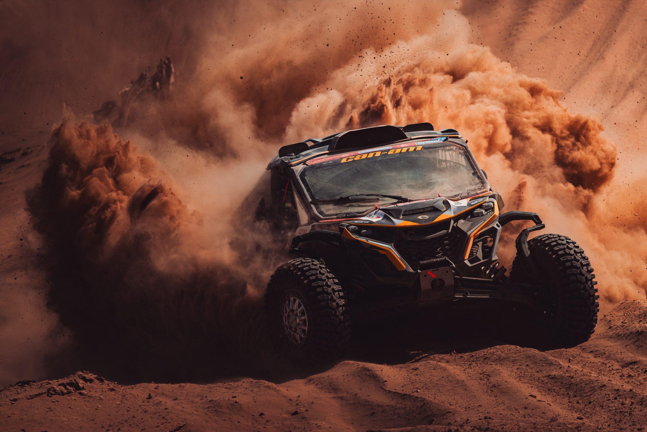 Hunter Miller Racing through the Saudi Arabian Desert in his yellow and black Factory Can-Am fitted with Maxxis Roxxzilla tires at the 2025 Dakar Rally.