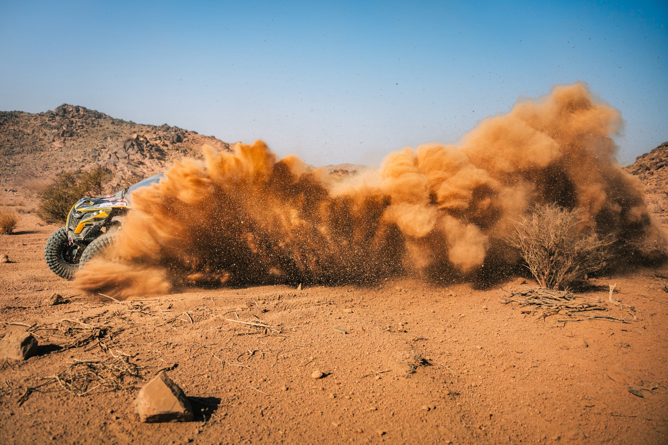 Hunter Miller Racing through the Saudi Arabian Desert in his yellow and black Factory Can-Am fitted with Maxxis Roxxzilla tires at the 2025 Dakar Rally.