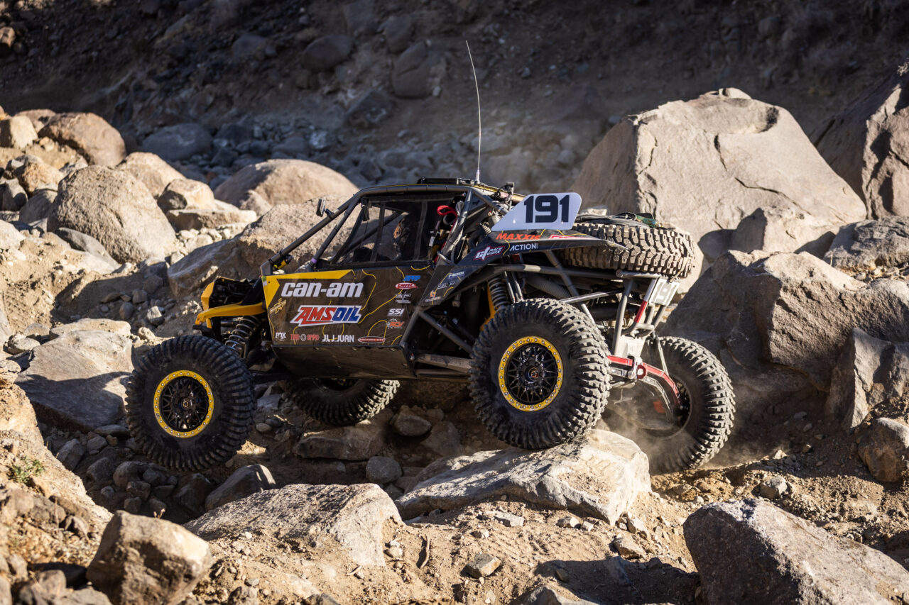Kyle chaney in his black and yellow CanAm SxS navigating a rock section in the 4400 Class race of KOH 2025.