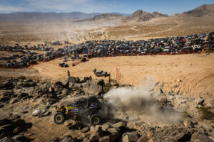 Kyle chaney in his black and yellow CanAm SxS navigating a rock section in the 4400 Class race of KOH 2025.