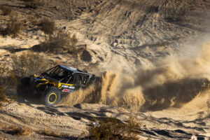 Kyle chaney in his black and yellow CanAm SxS navigating a rock section in the 4400 Class race of KOH 2025.