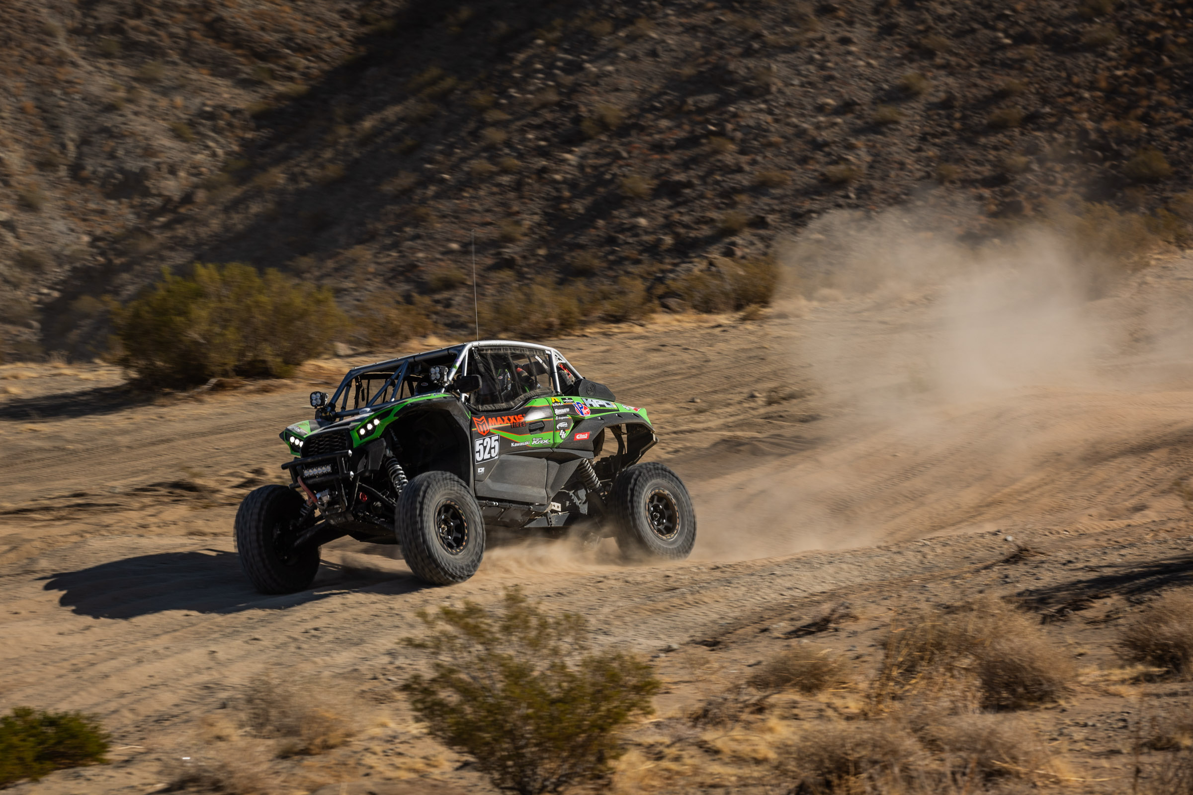 Jeremy McGrath in his Green KRX SxS blasting down a desert straight.