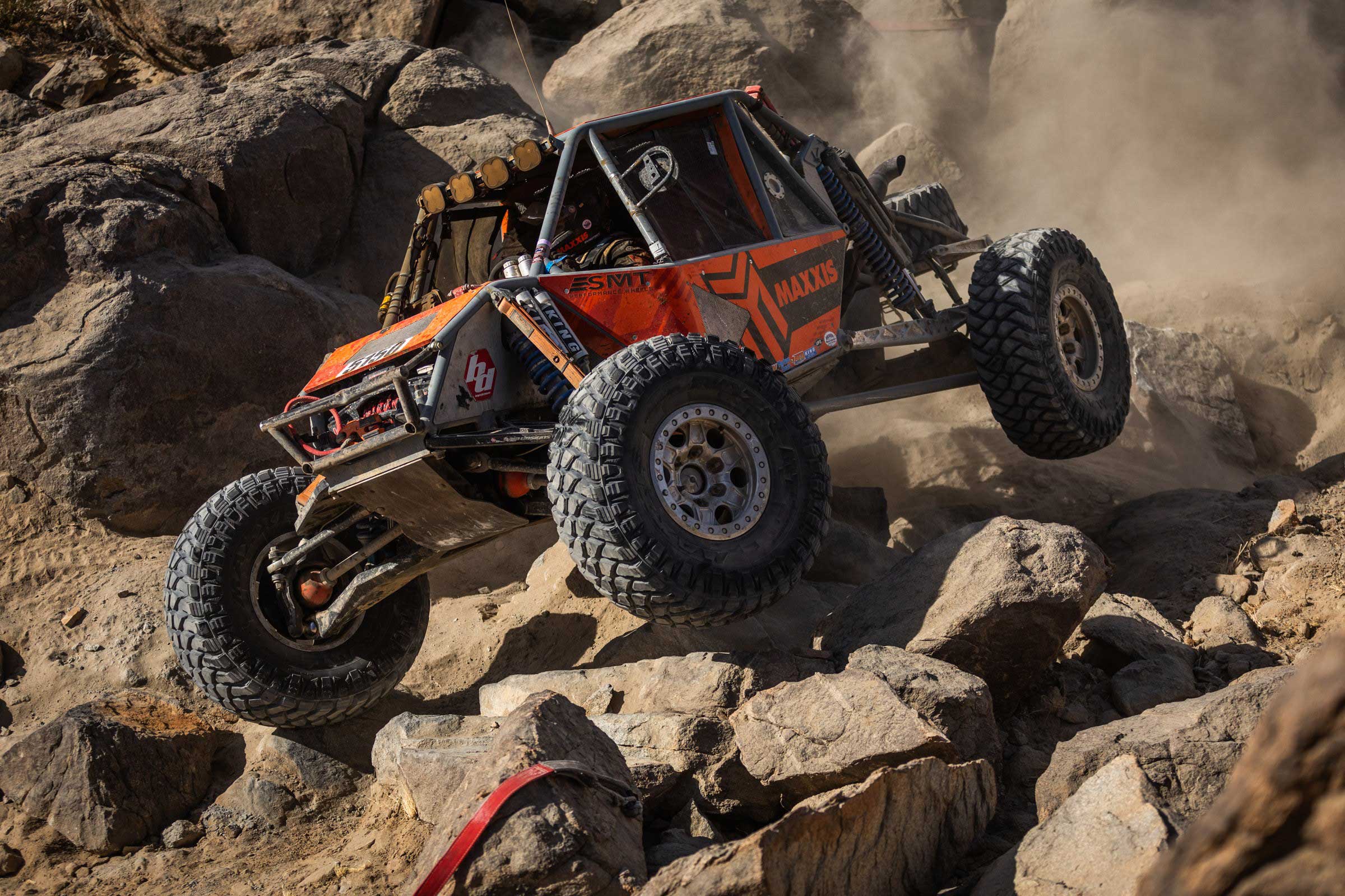 Maxxis athlete in 4400 car in the rocks