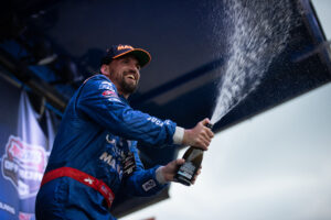 Maxxis athlete celebrating a win on the podium
