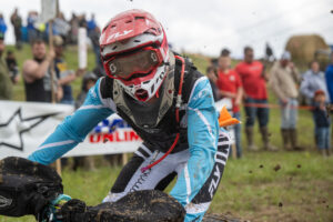 GNCC Maxxis athlete Hunter Hart staring down the camera man while riding his Quadcycle across the start straight during opening ceremonies of the Mason Dixon GNCC.