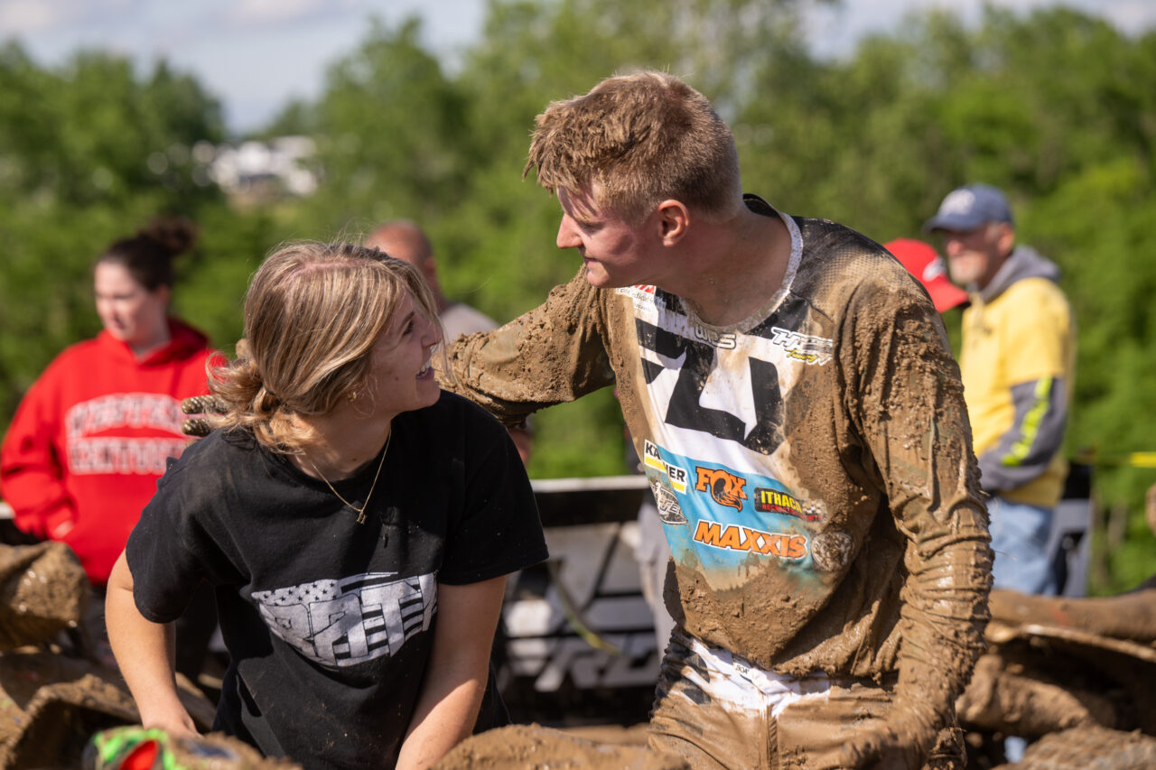 GNCC Maxxis athlete Hunter Hart patting a blonde lady on the head after winning a race.