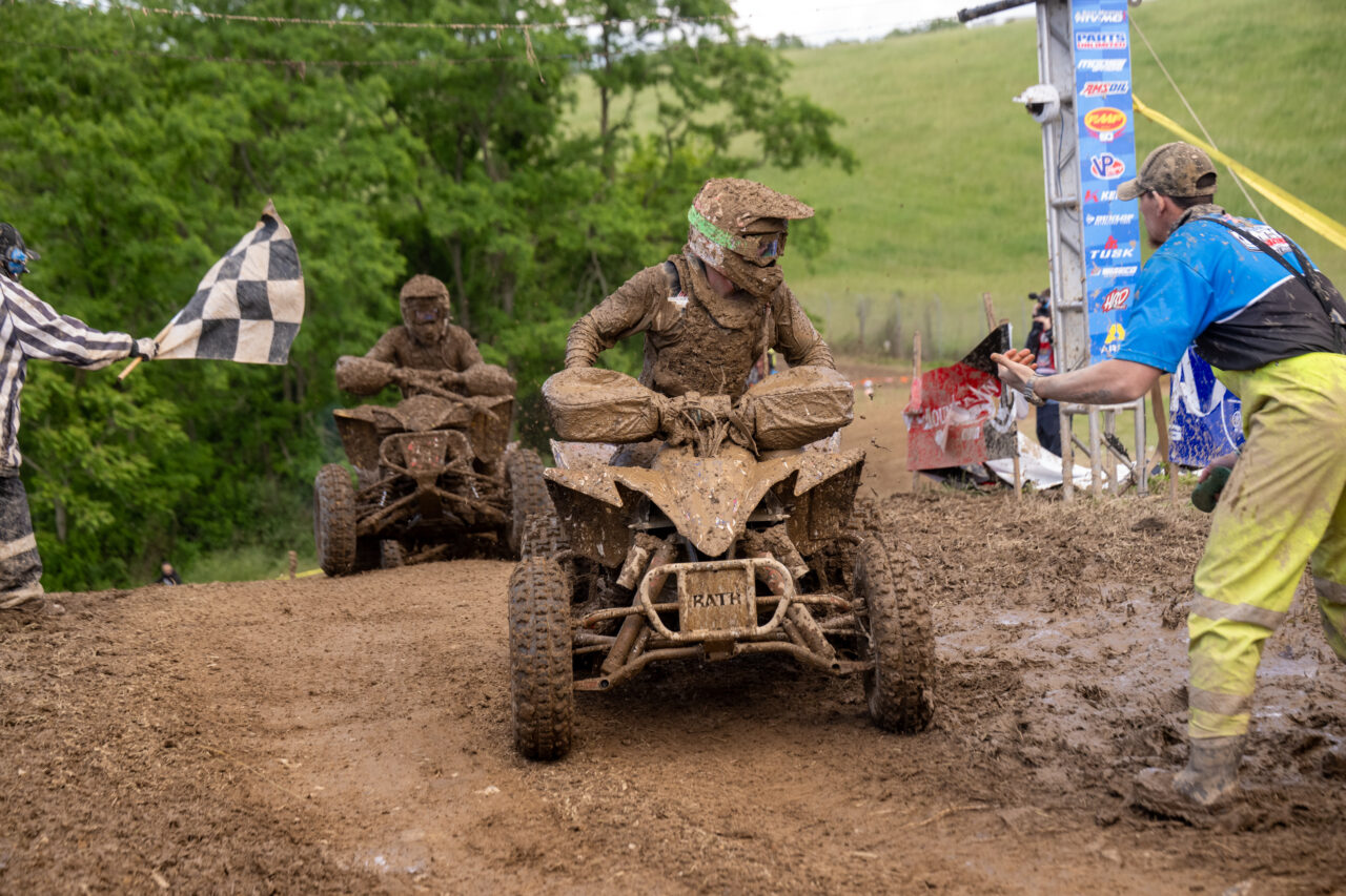 GNCC Maxxis athlete Hunter Hart coasting across the finish line of the Mason Dixon GNCC covered in Mud.