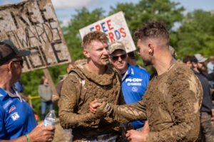 GNCC Maxxis athlete Hunter Hart congratulating Brycen neal on his podium finish. Both racers covered in mud.