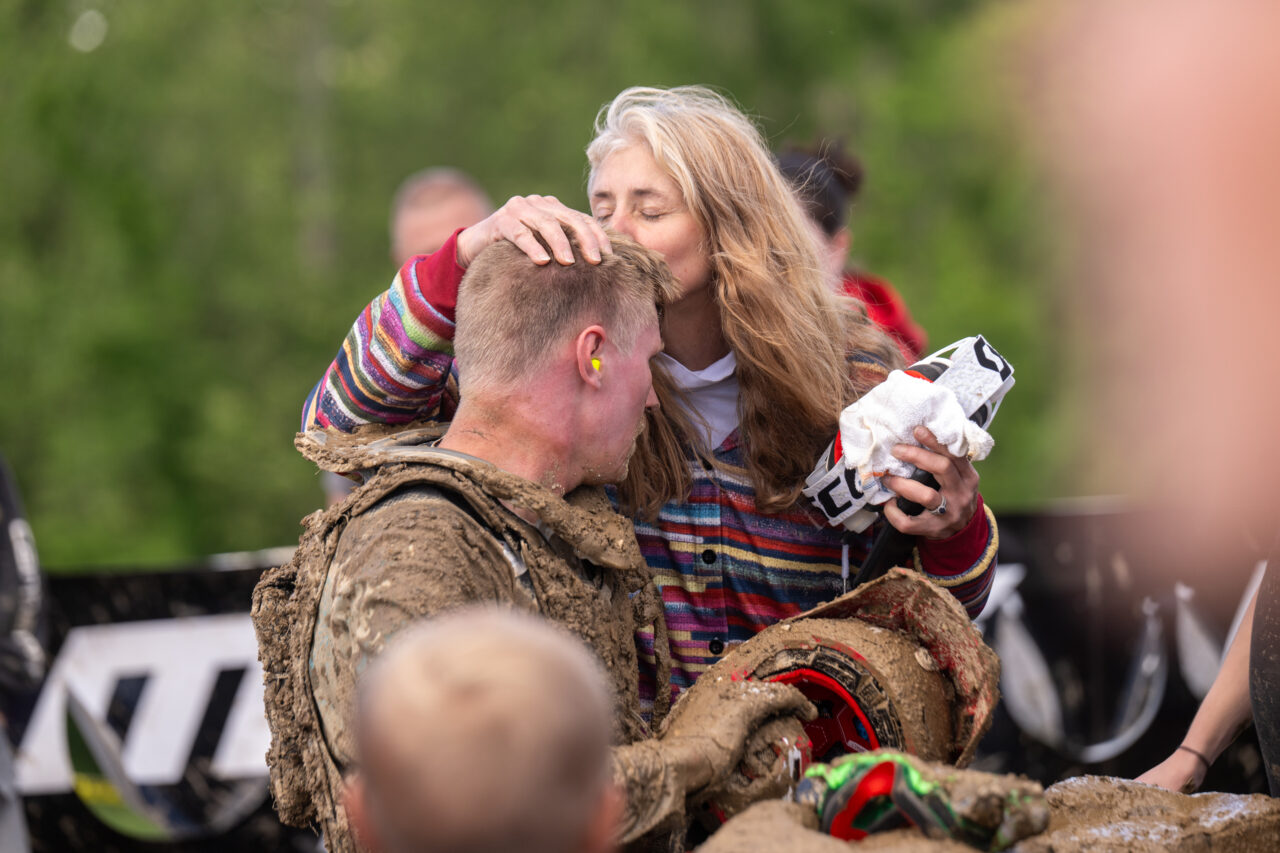 Amy Hart kissing her son (GNCC Maxxis athlete Hunter Hart) on the top of his head as only a mother can.