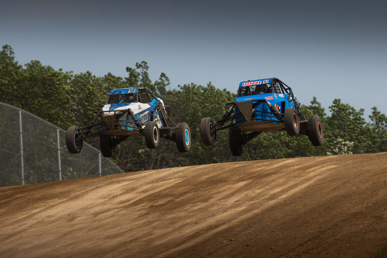 Two maxxis athletes on course - mid air