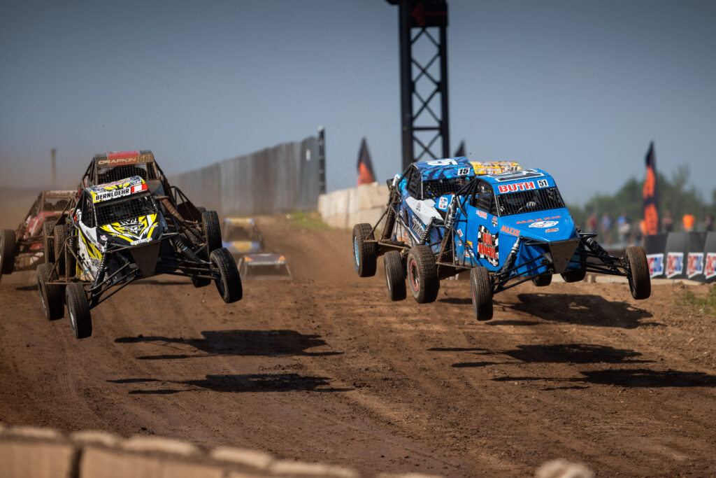 Lineup of cars on track, midair. 