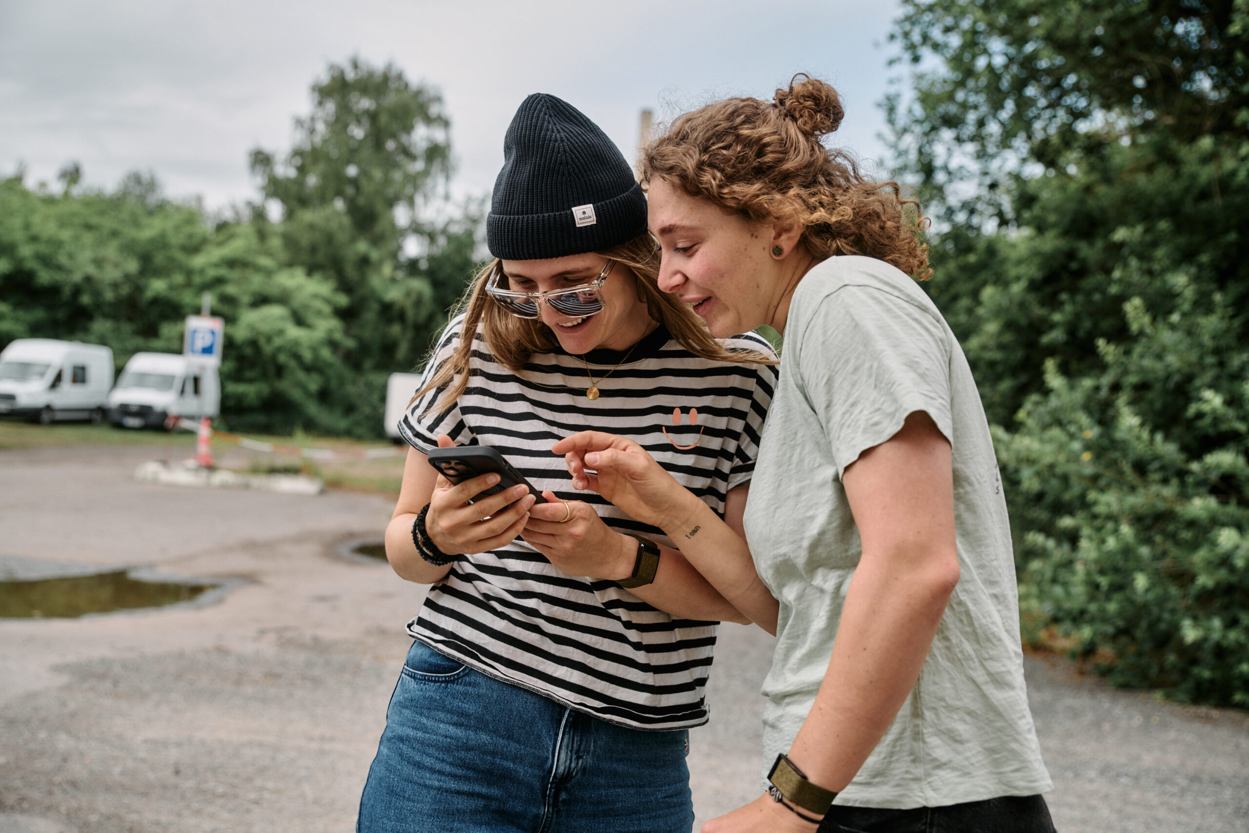 Two women review information on a smartphone