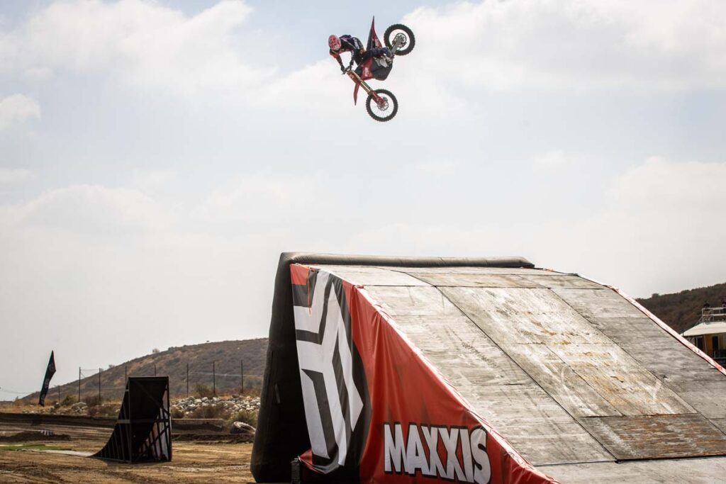 Maxxis athlete on the dirtbike, huge air over Jump
