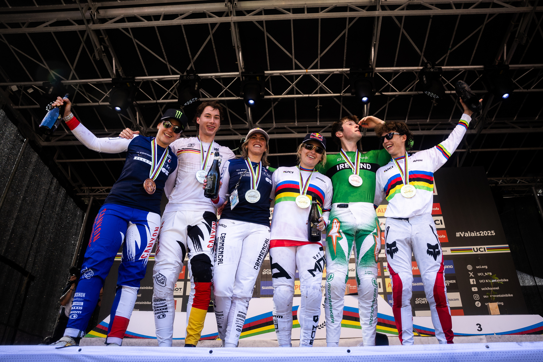 All downhill Elite medal winners on podium