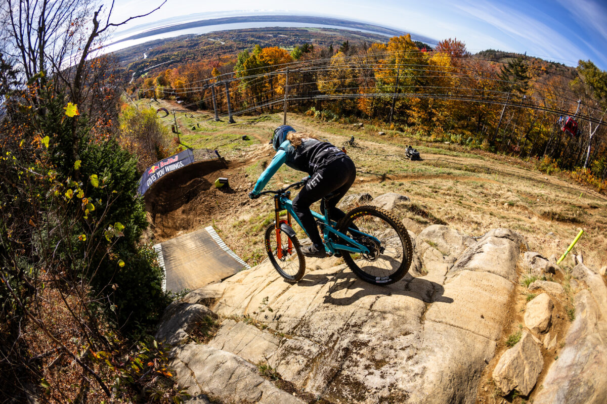 Rider dropping down rock