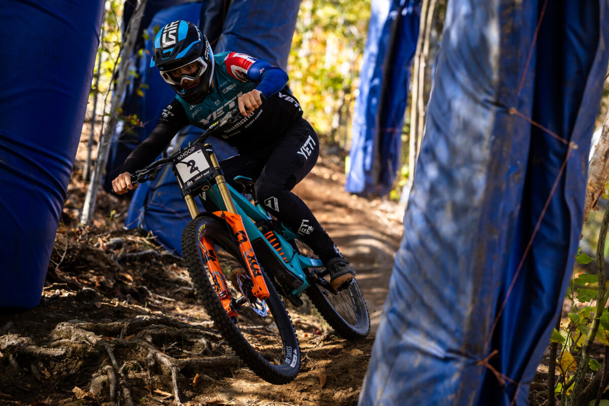 Yeti rider riding through trees