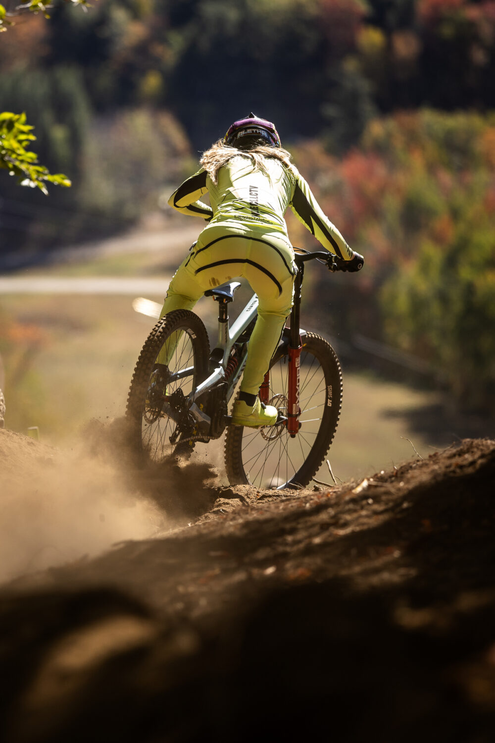 Shot from behind of Ostgaard Sliding on dirt