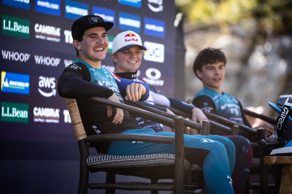 Junior Men sitting on podium laughing