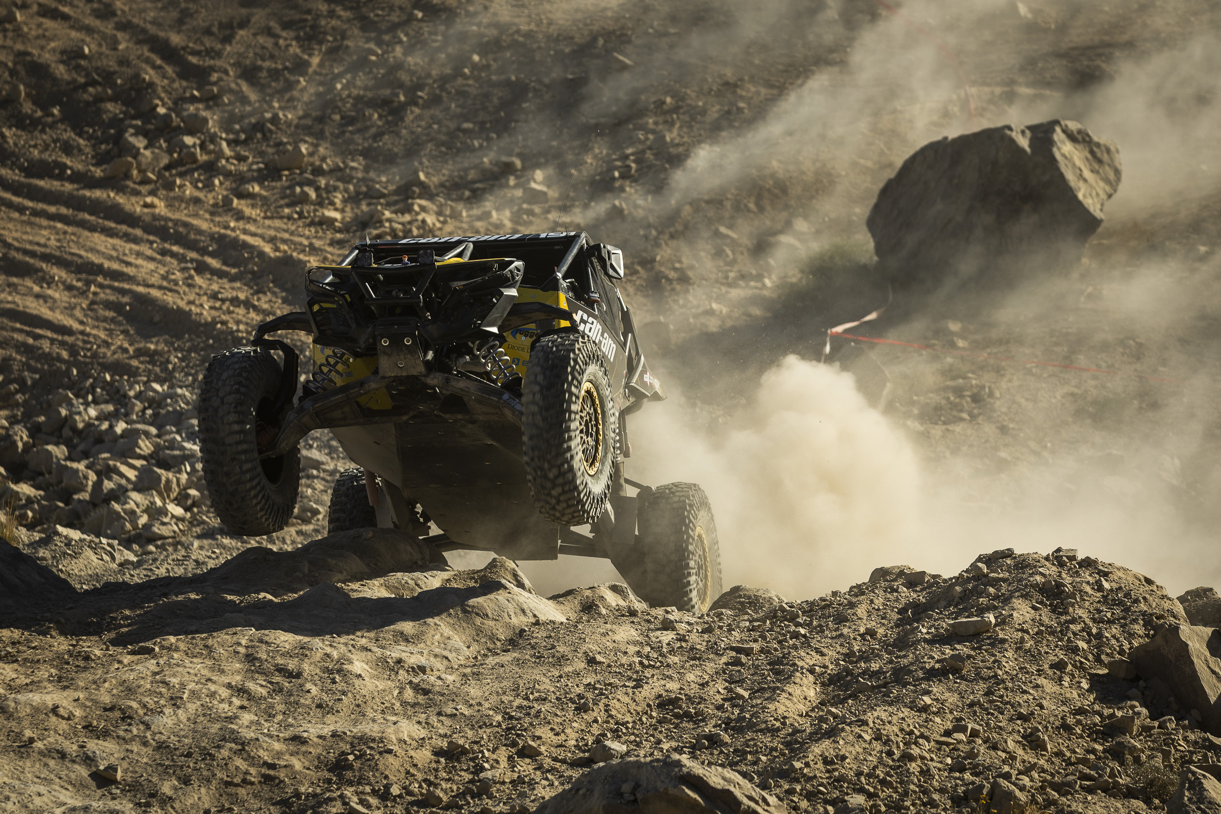yellow and black SxS about to take flight on a set of 37" Roxxzillas.