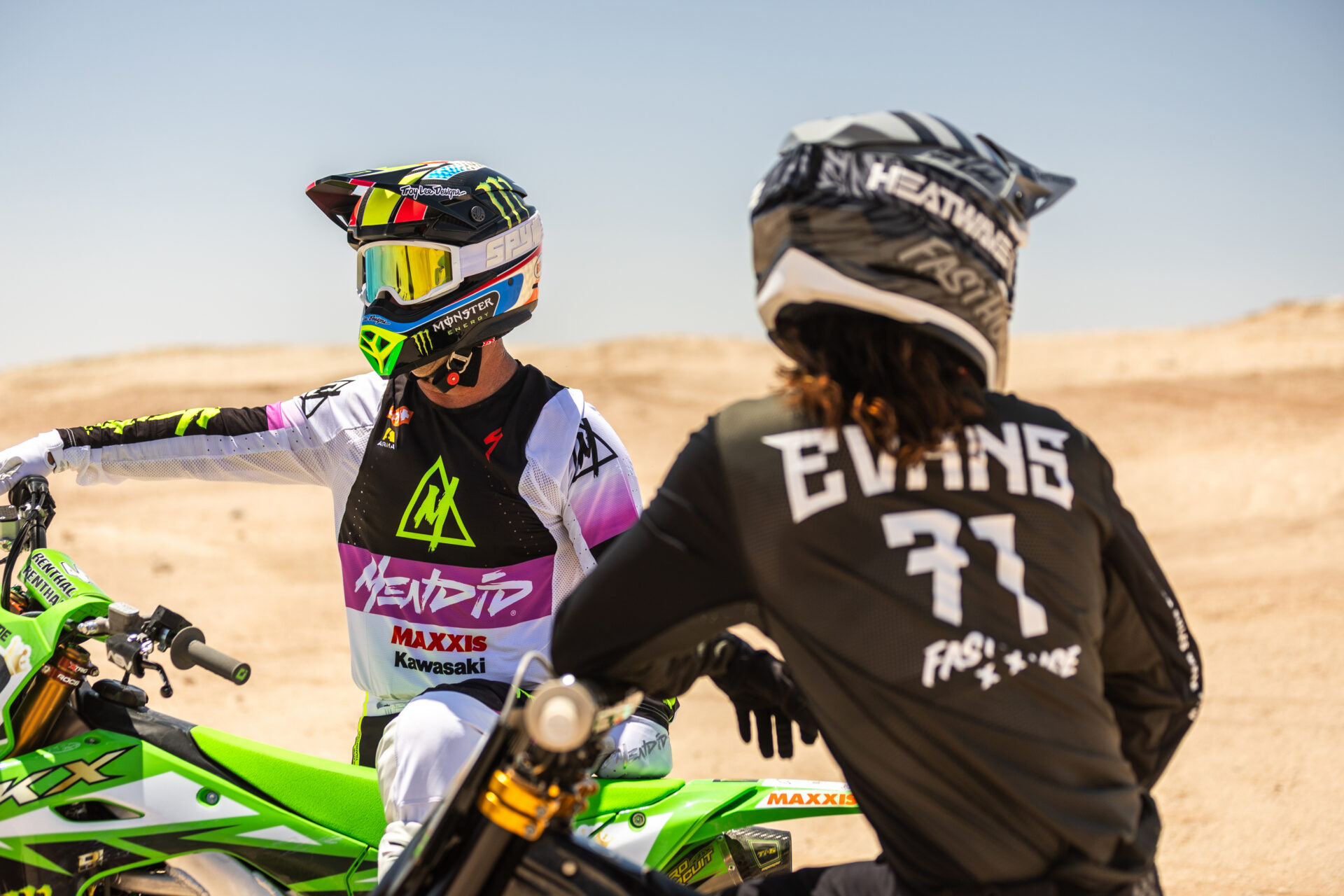 Jeremy McGrath and Patrick Evans sitting discussing a jump in the heat of Ocotillo wells desert in June.