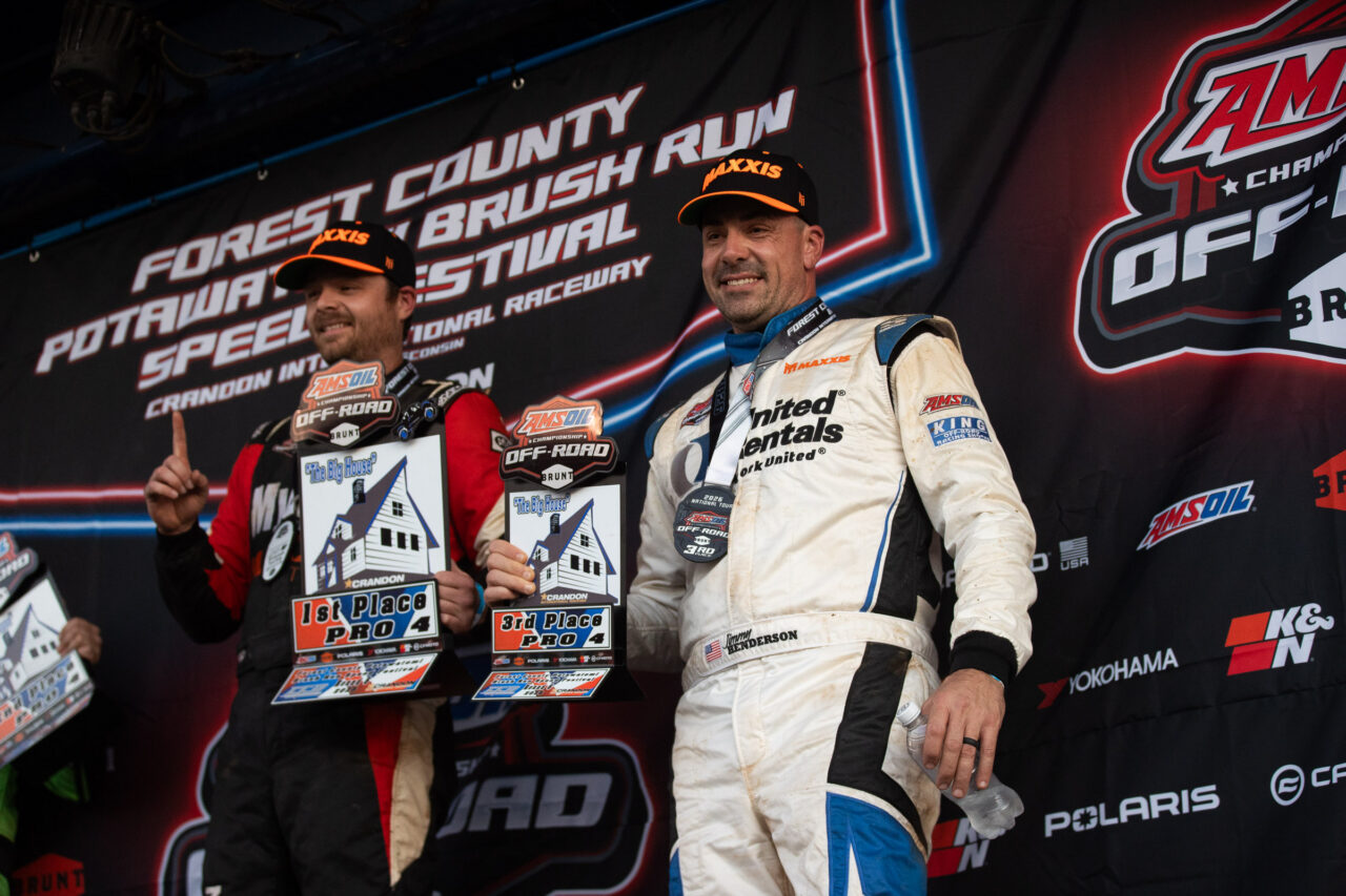 Mickey Thomas and Jimmy Henderson on the podium of the pro4 class at Crandon international. They are both posing for pictures after a race finish.