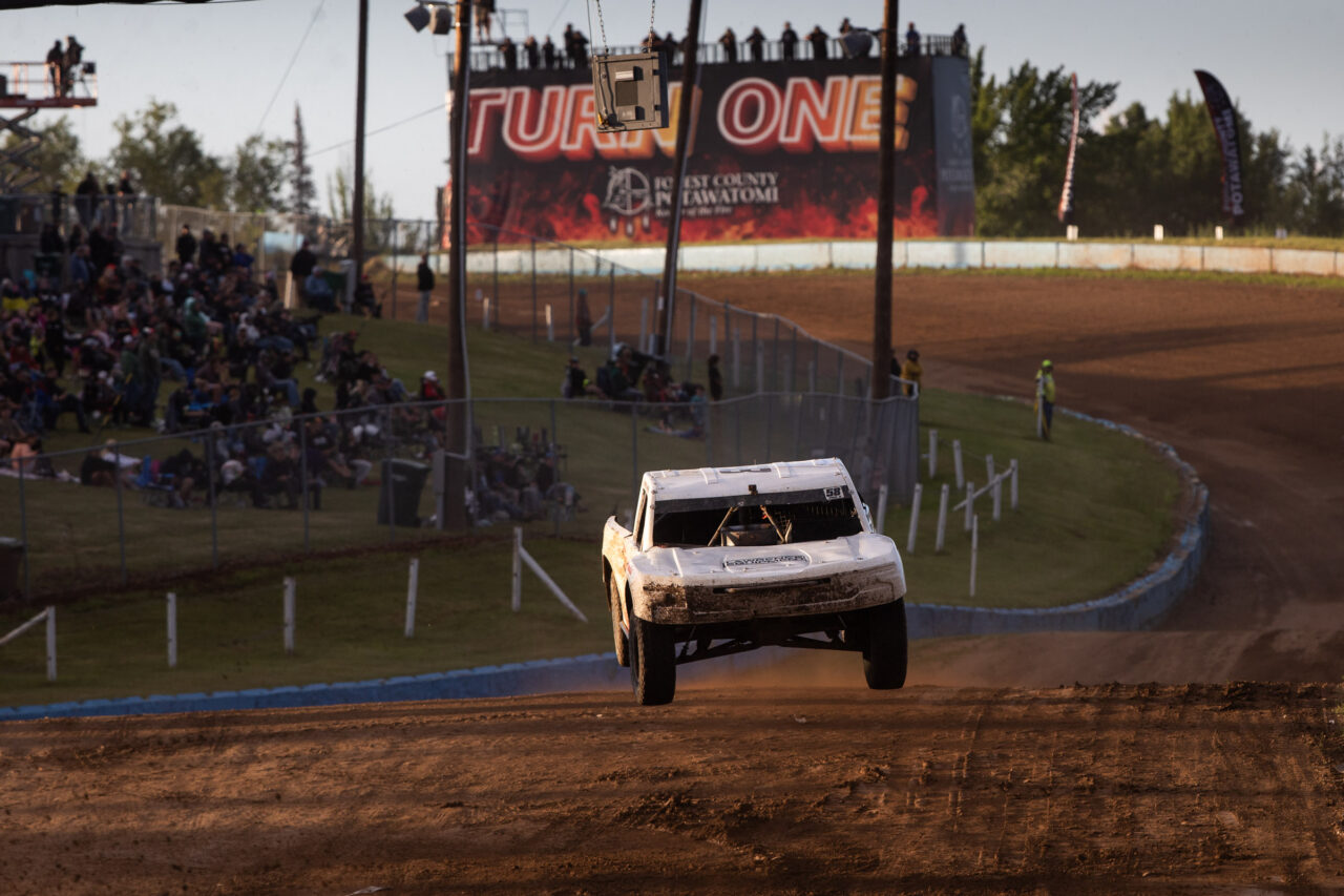 white truck bombing down the first turn hill of Crandon Offroad park.