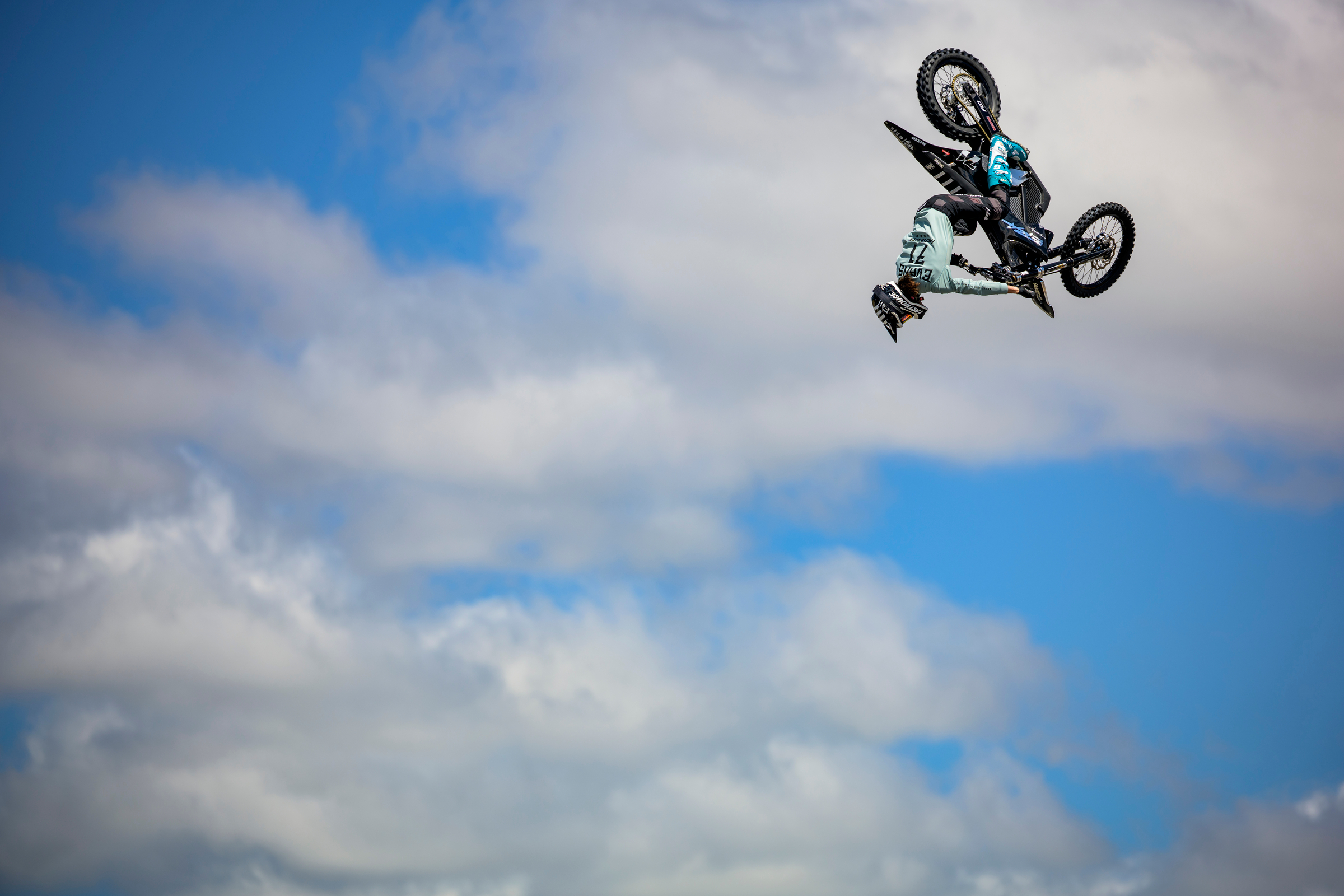 Dirt bike rider mid-flight with just sky in the background.