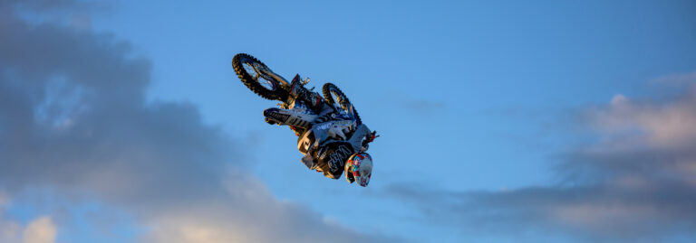 Dirt bike rider mid-flight with just sky in the background.