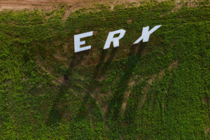 An aerial view displays large, white letters spelling 