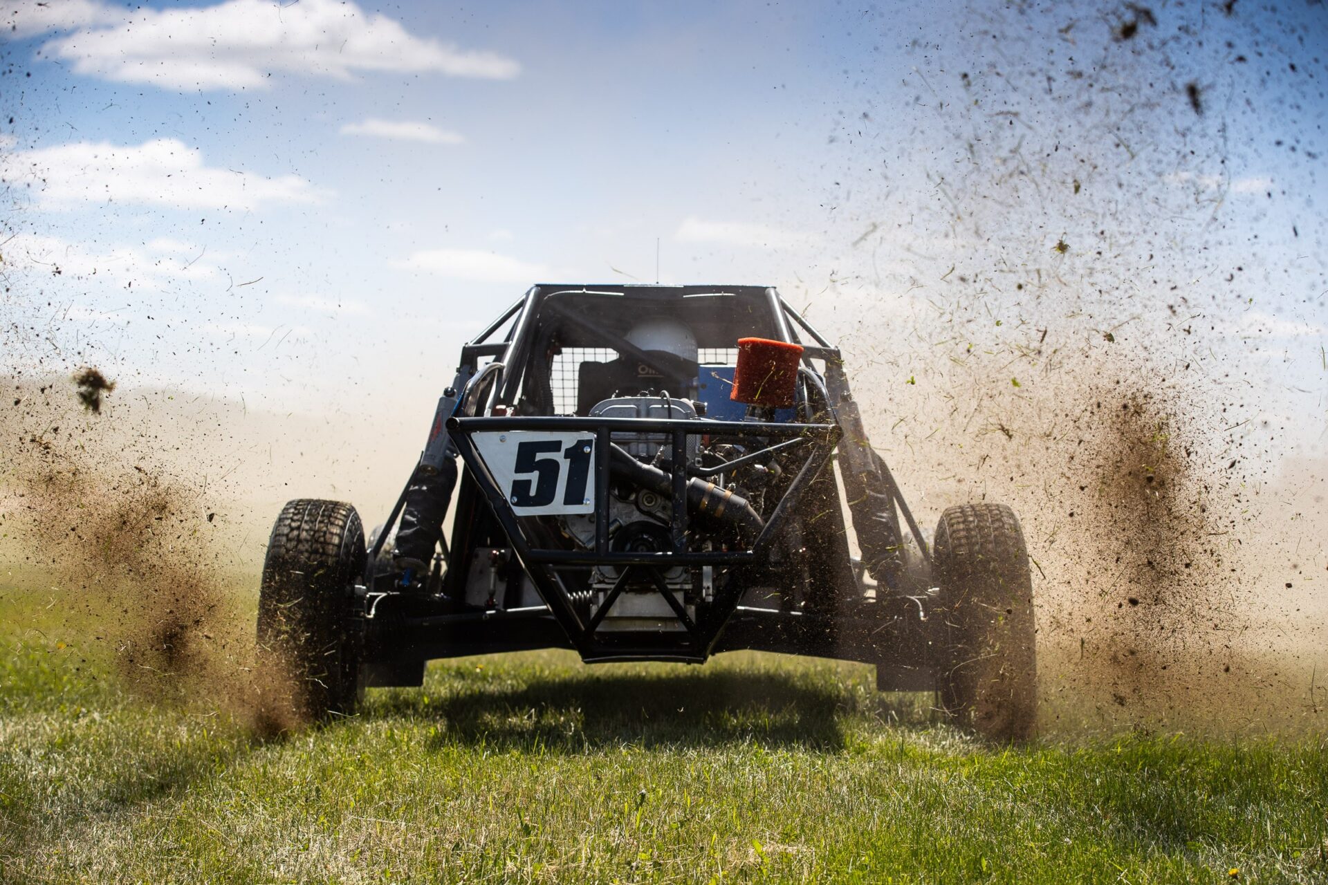 maxxis athlete throwing dirt up from rear tires